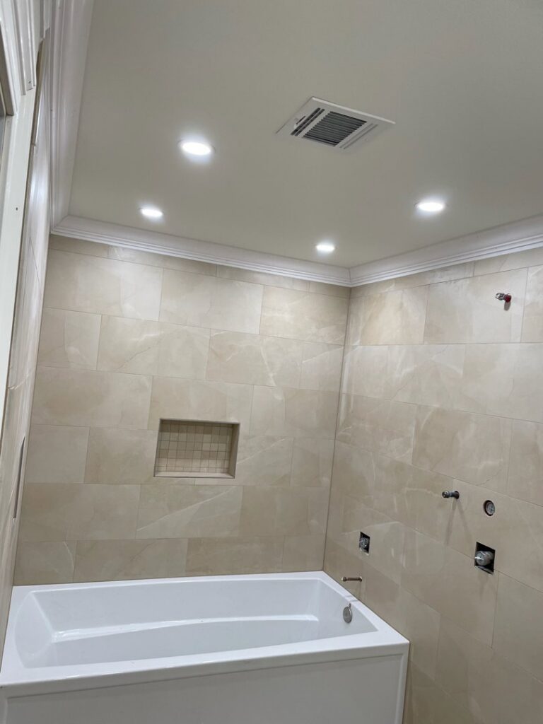 Bathroom with new recessed lighting and an exhaust fan installed by LiveWire Electrical Services, LLC. in Houma, LA.