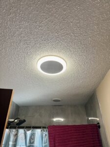 Modern recessed lighting fixtures installed in a bathroom ceiling by Lighten Up Electric, LLC in Cranston, RI.