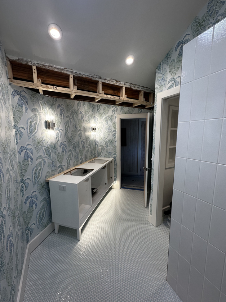 Bathroom renovation showing recessed lighting and wall sconces installed by Ampler Electrical Services in Wilmington, NC.