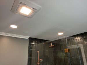 New recessed lighting and an exhaust fan installed in a bathroom by Abe Electric LLC in Wallingford, CT.