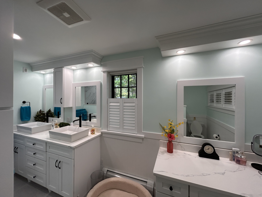Modern recessed and vanity lighting installed in a bathroom by Nuts And Volts Electric LLC in Farmington, NH.