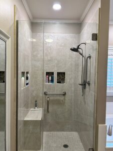 A recessed light installed above a tiled bathroom shower by LiveWire Electrical Services, LLC. in Houma, LA.