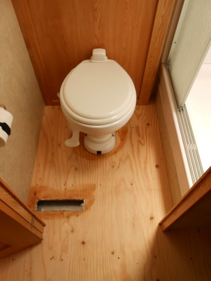 An exposed plywood subfloor in a bathroom, ready for new flooring installation by Frosty's Carpet Center, Inc. in Grand Forks, ND.