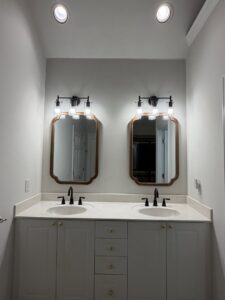 Newly installed bathroom vanity light fixtures above two sinks by Dr. Sparky in Nashville, TN
