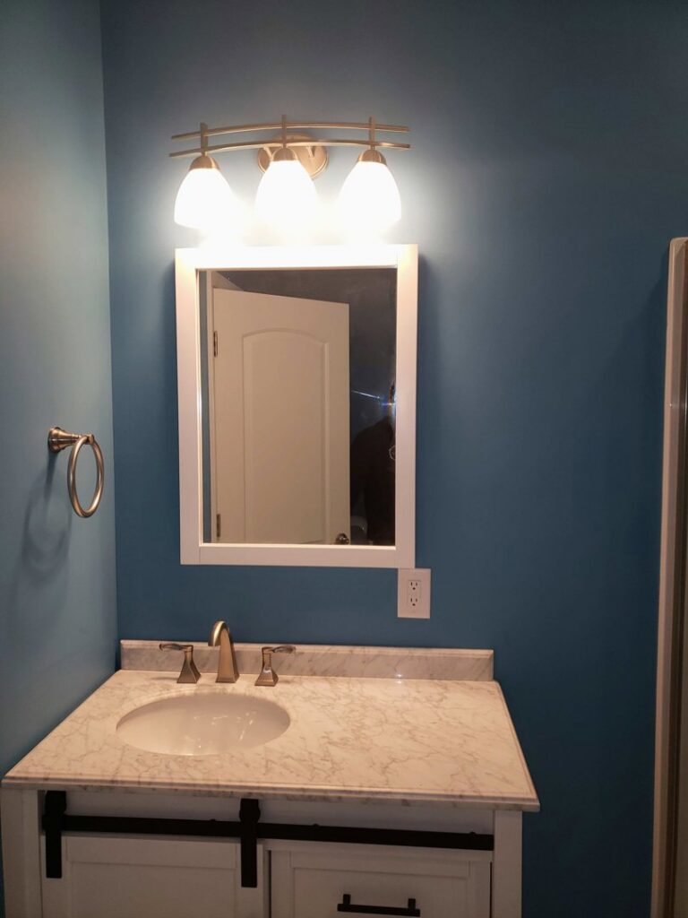 New bathroom vanity light fixture and electrical outlet installed by Fiedler Electric in Higginsville, MO.