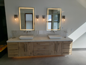 Bathroom vanity with illuminated mirrors, wall sconces, and under-cabinet lighting by TBS Electric, West Jordan, UT.