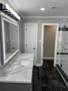 New vanity light fixture and recessed lighting installed in a modern bathroom by C. C. Taylor Electric LLC in Powhatan, VA.