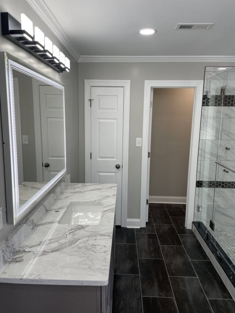 New vanity light fixture and recessed lighting installed in a modern bathroom by C. C. Taylor Electric LLC in Powhatan, VA.