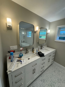 Bathroom vanity with new wall sconces and light switches, recently installed by P. Cruz Electric LLC in Springfield, MA.