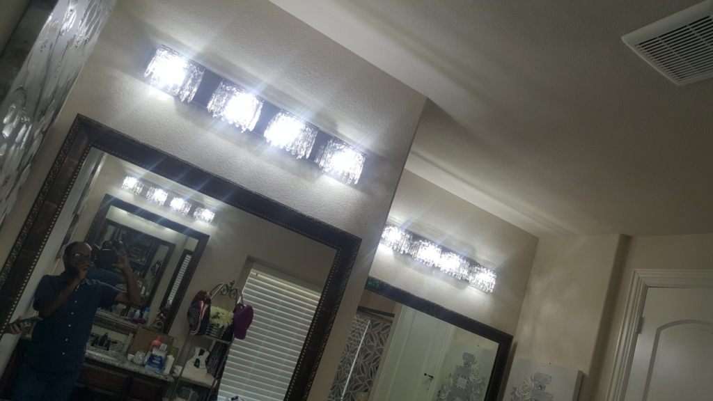 New bathroom vanity lighting installed above a mirror by Zaheer Electrical Plus in Dallas, TX.
