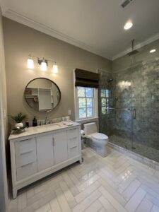 A modern bathroom featuring new vanity lighting and recessed ceiling lights installed by Copper And Current Electrical Services in Greensboro, NC.