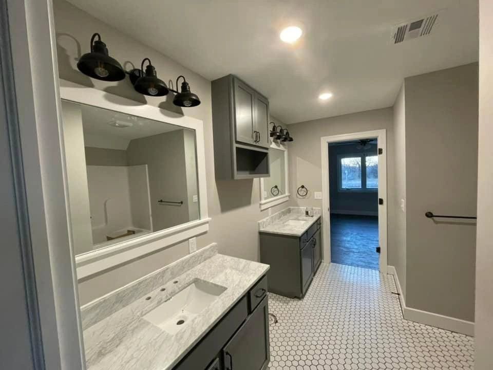 Bathroom featuring vanity sconces and recessed lighting installed by Innovative Electric in Wichita, KS.
