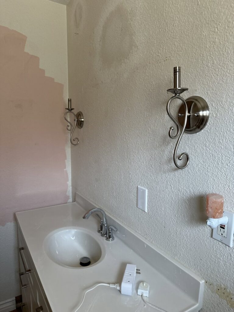 New bathroom wall sconces installed above a vanity by Steve Cavenee Electric in Orange, CA.