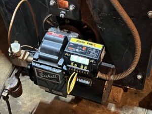 A close-up of a Beckett Carlin Pro X burner control on a heating system serviced by Tapper Energy in Dauphin, PA.