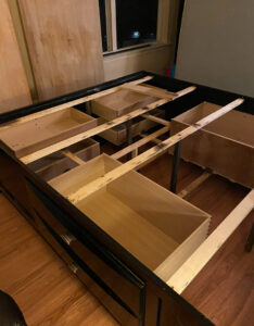 A bed frame with drawers removed, likely in preparation for a bed bug or pest treatment by Bed Bug and Pest Removal LLC in Baltimore, MD.