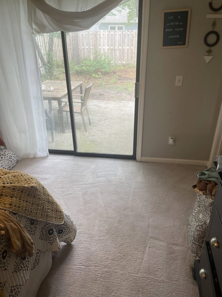 A bedroom carpet showing fresh cleaning results and vacuum lines by Wilmington Carpet Cleaning NC in Wilmington, NC.