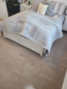 A bedroom carpet showing professional cleaning results and vacuum lines by Wilmington Carpet Cleaning NC in Wilmington, NC.