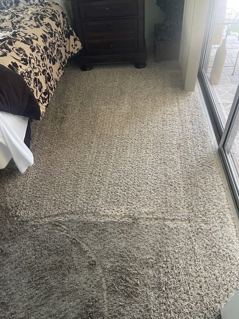 Carpet cleaning in progress in a bedroom, showing clean and dirty sections, by The Best Carpet & Tile Cleaners in Alva, FL.