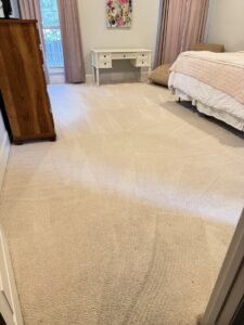 A bedroom carpet showing fresh cleaning lines after service by Jones Carpet Care LLC in Huntsville, AL.