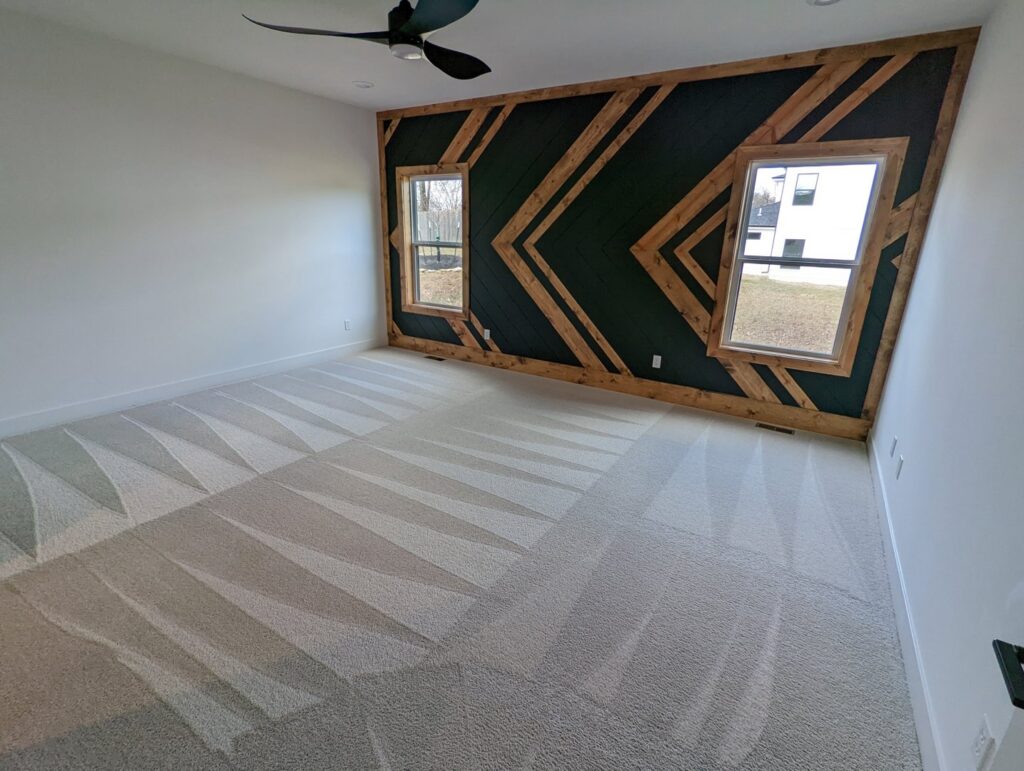 A spacious bedroom with light-colored carpet displaying fresh cleaning patterns from Dewdrop Carpet Cleaning in Kansas City, MO.