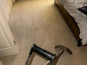 Professional carpet cleaning in a bedroom using a cleaning wand by Sun Valley Home Maintenance LLC in Chandler, AZ.
