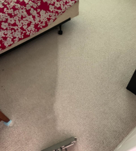 A carpet cleaning wand in action on a bedroom carpet by Evolution Carpet Cleaning in Fresno, CA