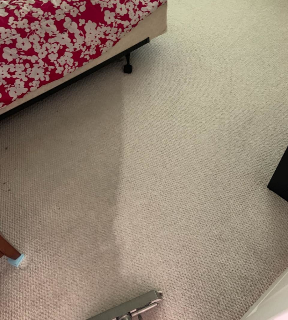 A carpet cleaning wand in action on a bedroom carpet by Evolution Carpet Cleaning in Fresno, CA