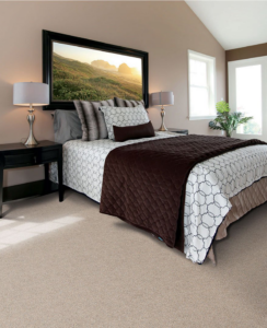 A cozy bedroom showcasing new wall-to-wall carpet installed by Avalon Flooring in Toms River, NJ