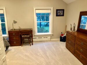 A bedroom with new light beige carpet installed by Carpet King and Flooring in Myrtle Beach, SC.