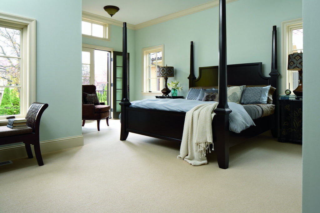 A cozy bedroom featuring new wall-to-wall carpet installed by Carpet One Floor & Home Denver in Denver, CO.
