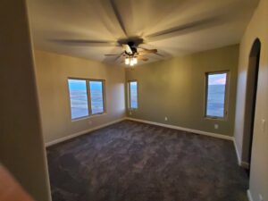 A newly carpeted bedroom, showcasing professional carpet installation by Cheyenne Tile And Stone in Cheyenne, WY.