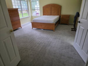 A newly installed light gray patterned carpet in a bedroom by FloorCrafters in Toms River, NJ