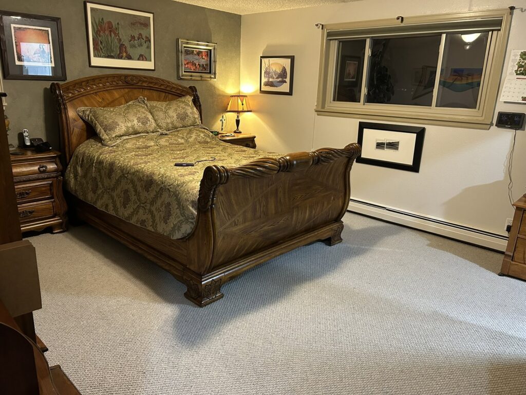 A newly installed light-colored carpet in a bedroom, showcasing a finished project by Front Range Interiors in Greeley, CO.