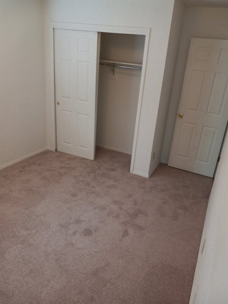 Newly installed light brown carpet in a bedroom by Lansa Works, a professional carpet contractor in Phoenix, AZ