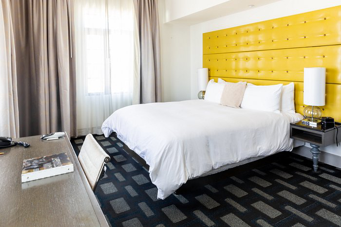 A bedroom featuring a stylish patterned carpet installed by Paul Rodriguez Flooring in Bakersfield, CA.
