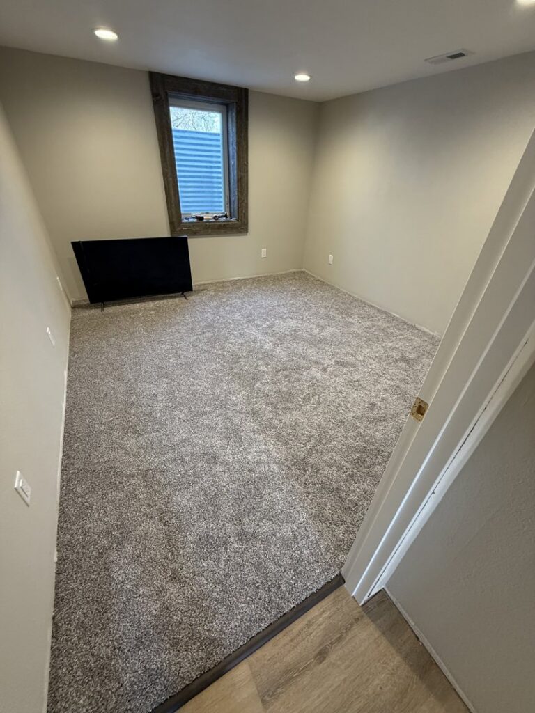 Freshly installed carpet in a cozy bedroom by Rayman Flooring, a carpet contractor in Aberdeen, SD