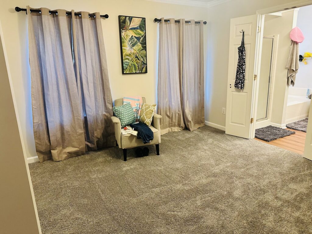 A wide view of a bedroom with new gray carpet installed by Rocky Flooring in Greer, SC.