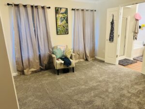 A wide view of a bedroom with new gray carpet installed by Rocky Flooring in Greer, SC.
