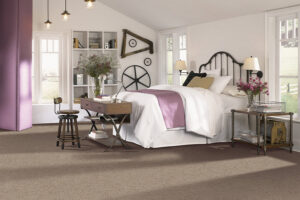 A bedroom featuring new brown carpet installed by Seacoast Flooring in Saco, ME.