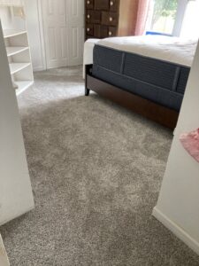 Newly installed gray carpet in a bedroom by Tile Town Carpet One in Syracuse, NY