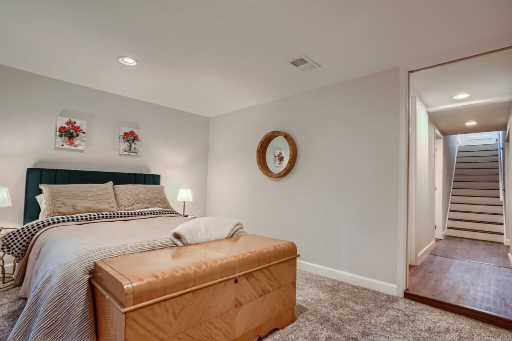 A newly installed carpet in a cozy bedroom, showcasing a completed job by Wagner Floors in Littleton, CO.