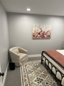 A bedroom with new wall-to-wall carpet and a decorative area rug installed by Universal Flooring in Idaho Falls, ID.
