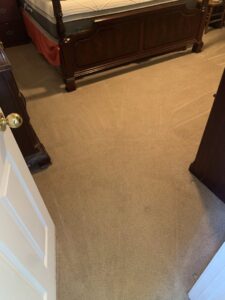 A bedroom carpet showing distinct cleaning lines after service by Floor Medics in Huntsville, AL