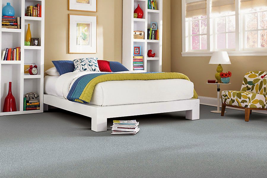 A modern bedroom featuring a fresh light blue carpet installation by CR Flooring in Atlanta, GA