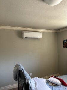 An indoor mini-split head unit installed on a bedroom wall by A's Heating and Cooling LLC in Portland, OR.