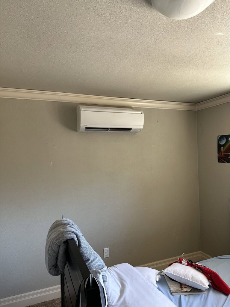 An indoor mini-split head unit installed on a bedroom wall by A's Heating and Cooling LLC in Portland, OR.