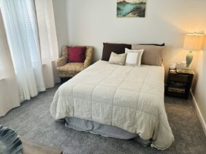 A comfortable bedroom featuring new gray carpet installed by Rocky Flooring in Greer, SC.