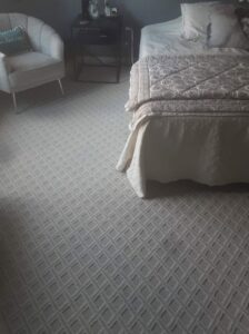 A bedroom featuring newly installed patterned gray carpet by Jerry's Carpet Sales and Service in York, PA.
