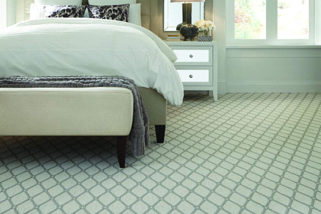 A stylish patterned carpet installed in a bedroom by West Michigan Flooring & Interiors, serving Grand Rapids, MI.