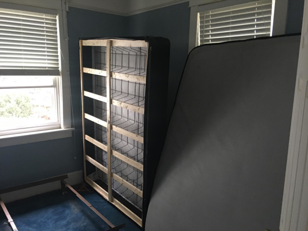 A bedroom with a mattress and box spring upright, prepared for bed bug treatment by Everything Bed Bugs, Removal & Remediation in Edison, NJ.